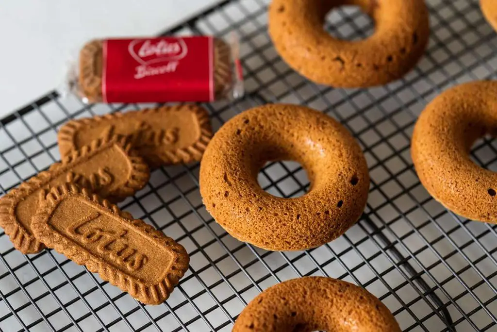 The donuts are baked and cooled before the glaze and finishing touches are added. Recipe by movers and bakers