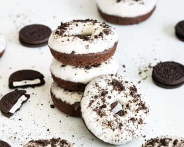 Delicious cakey, chocolatey Oreo donuts are light and delicious, topped with a yummy tangy cream cheese glaze. Recipe by movers and bakers