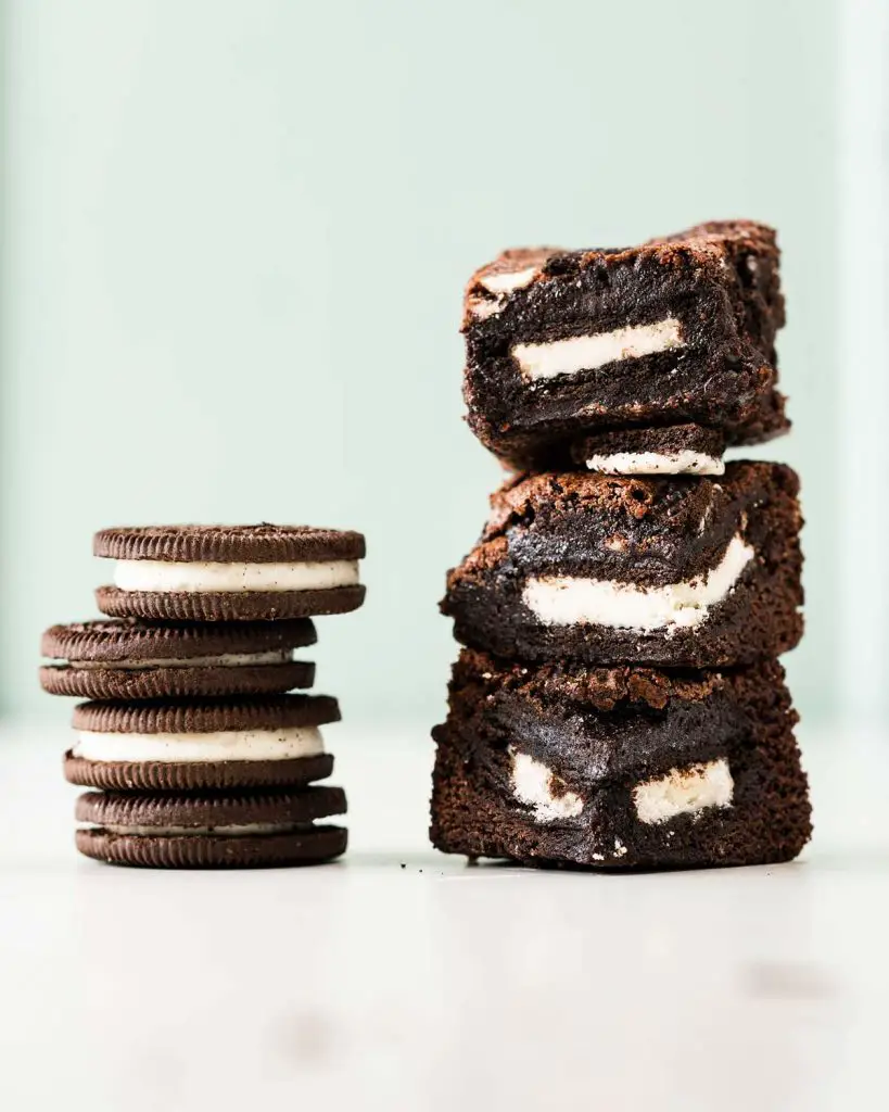 Oreo stuffed brownies. Deeply dark and rich, these brownies have an Oreo layer in the middle and more broken biscuits on top. Oreo heaven! Recipe by movers and bakers