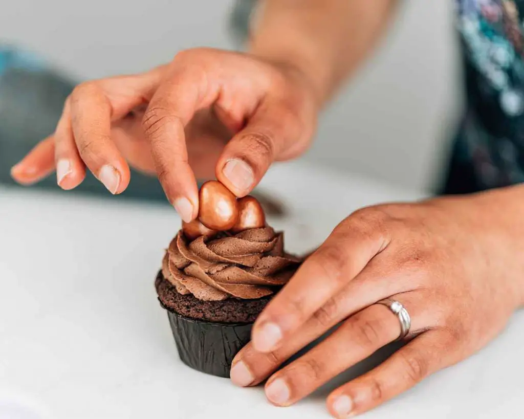 Decorating the caramel chocolate cupcakes with some galaxy enchanted eggs. A delicious Easter bake, recipe by movers and bakers