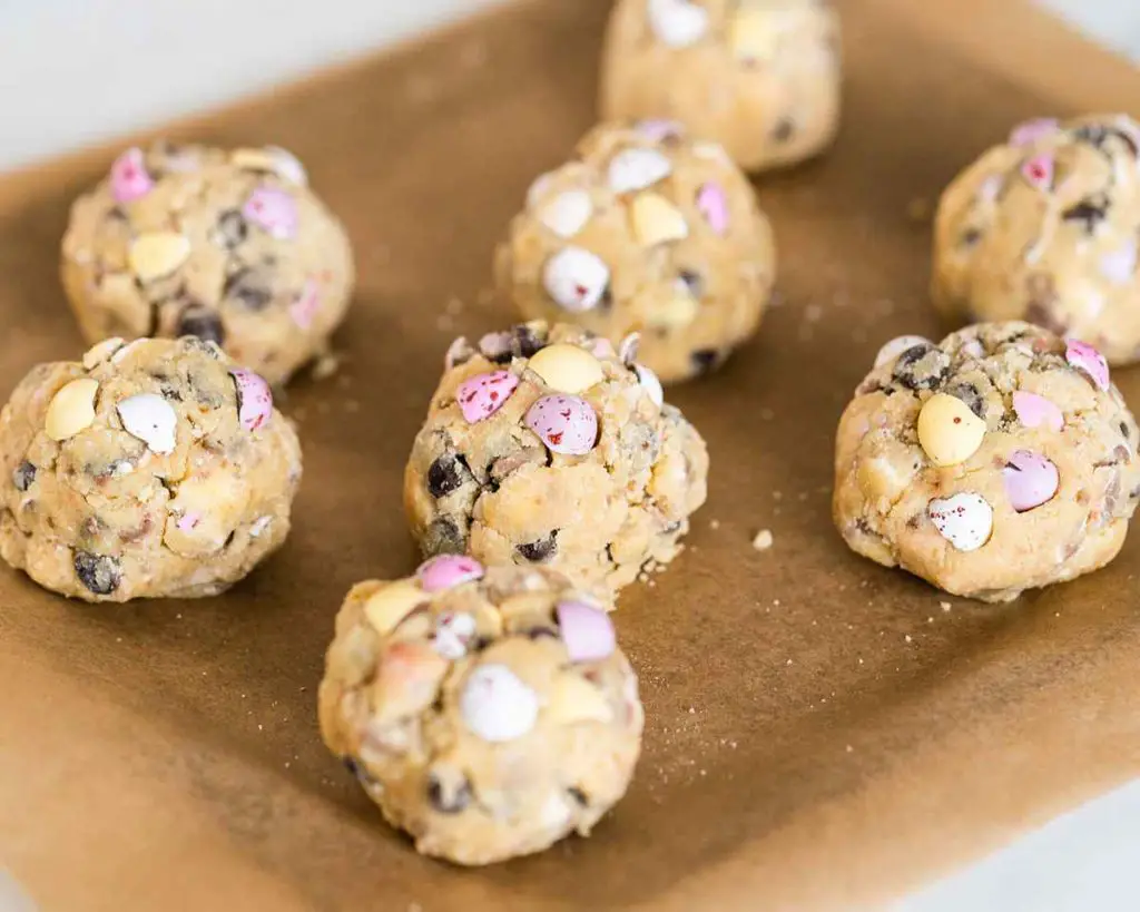 Cookies weighed, pressed together and studded with extra mini eggs before being chilled then baked. Recipe by movers and bakers