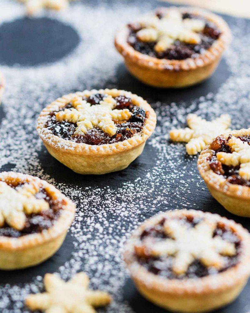 Mini mince pies. Perfect little festive bites, made with beautiful flakey and buttery shortcrust pastry, a boozy homemade mincemeat and topped with an adorable snowflake pastry! Recipe by movers and bakers