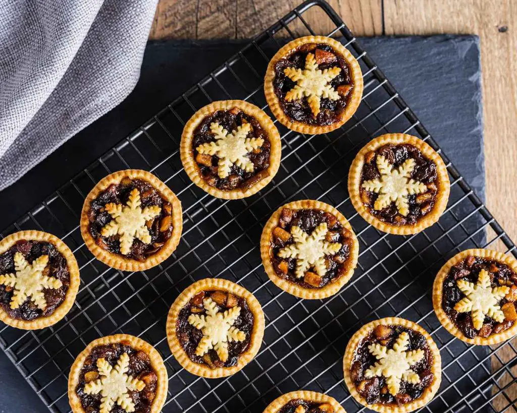 Mini mince pies. Perfect little festive bites, made with beautiful flakey and buttery shortcrust pastry, a boozy homemade mincemeat and topped with an adorable snowflake pastry! Recipe by movers and bakers