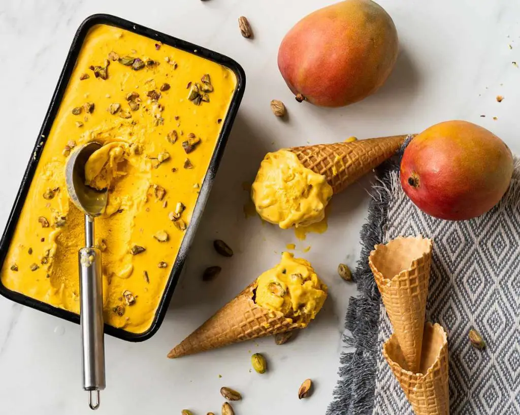 Mango kulfi. Creamy no churn mango ice cream with pistachio and cardamom makes the most heavenly summertime treat! Recipe by movers and bakers