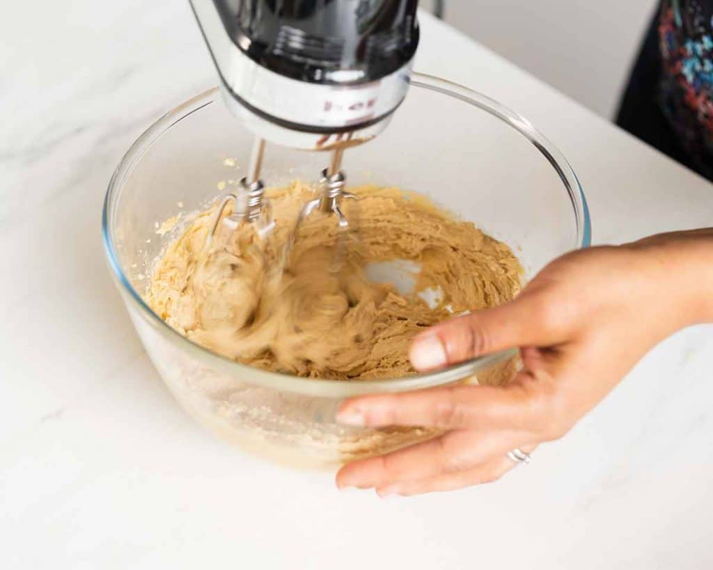 Beating together the butter and sugars for triple chocolate chip NYC cookies. Recipe by movers and bakers