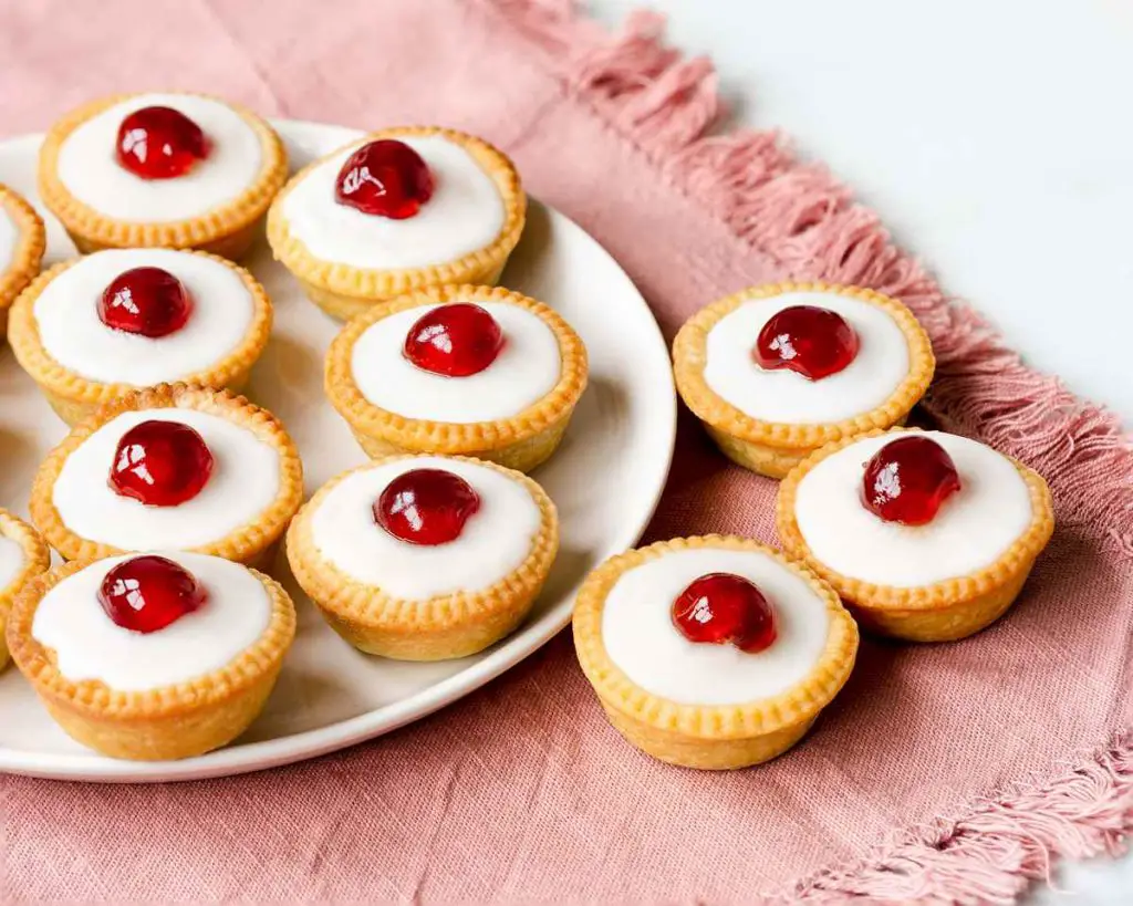 Cherry bakewell tartlets. Cherry and almond in a sweet shortcrust pastry topped with smooth icing and a glacé cherry half. Heaven! Recipe by movers and bakers