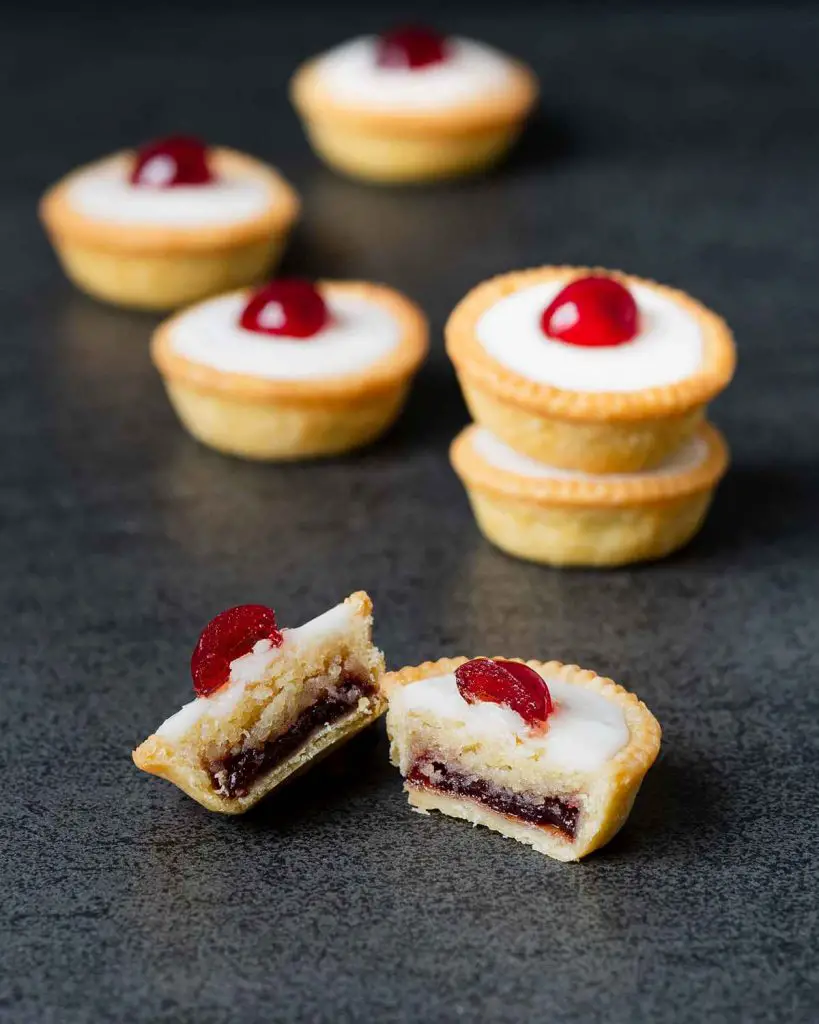 Cherry bakewell tartlets. Cherry and almond in a sweet shortcrust pastry topped with smooth icing and a glacé cherry half. Heaven! Recipe by movers and bakers