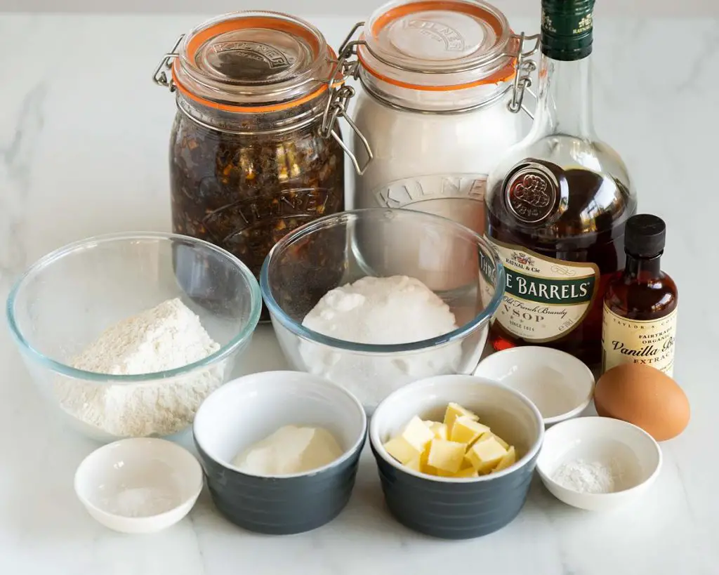 Ingredients required: plain (all purpose) flour, caster sugar, baking powder, bicarbonate of soda (baking soda), salt, unsalted butter, eggs, vanilla extract, yogurt, mincemeat, icing (powdered) sugar, brandy and silver sugar balls. Recipe by movers and bakers