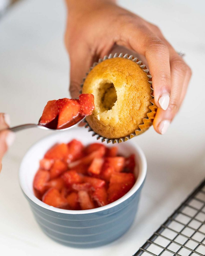 filling cupcakes with boozy strawberries