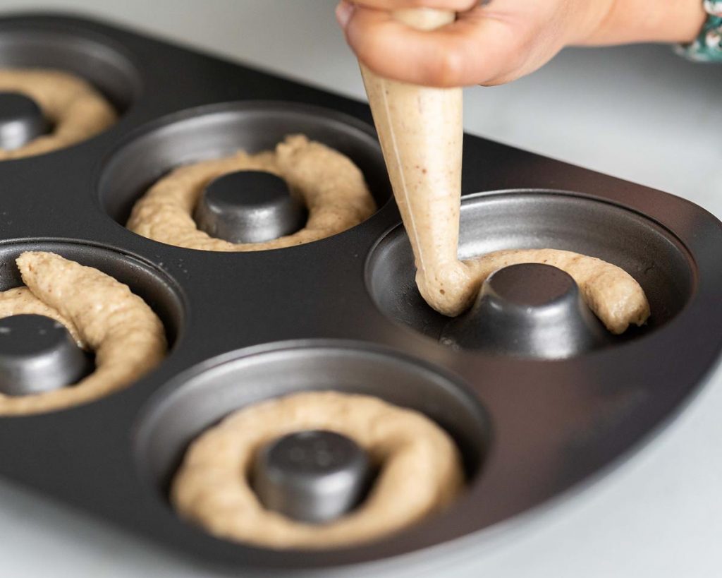Filling a #wilton donut pan with mixture before baking the donuts #moversandbakers #egglessdonuts #cinnamonsugardonuts #recipeforegglessdonuts