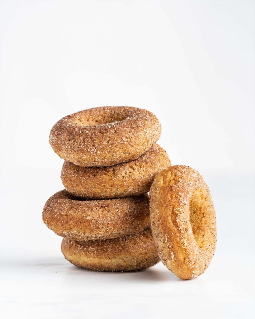Stack of four donuts with an additional one to the side