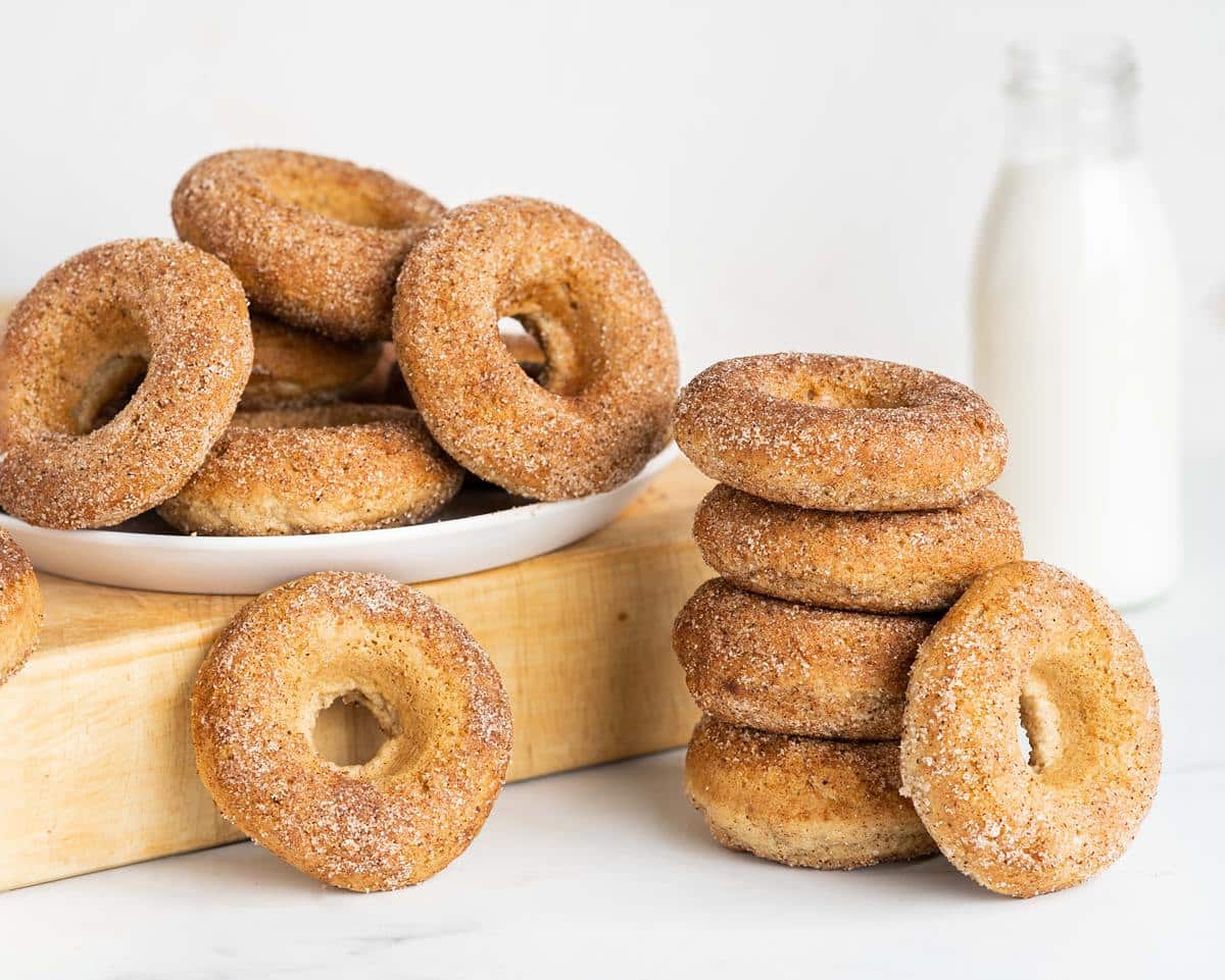 My eggless baked doughnuts are light and fluffy and so moreish! Cover simply in cinnamon sugar or dip in a glaze and enjoy! Recipe by movers and bakers