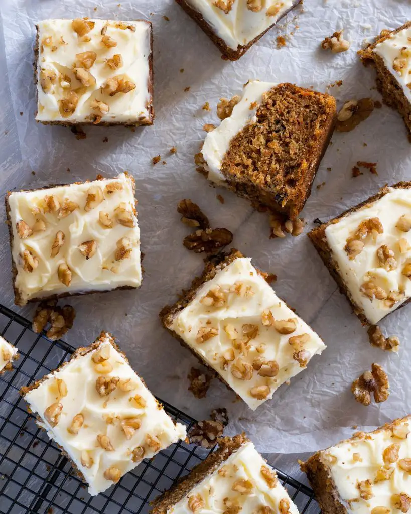 food holidays: carrot cake tray bake with walnuts and lashings of cream cheese icing. Recipe by movers and bakers