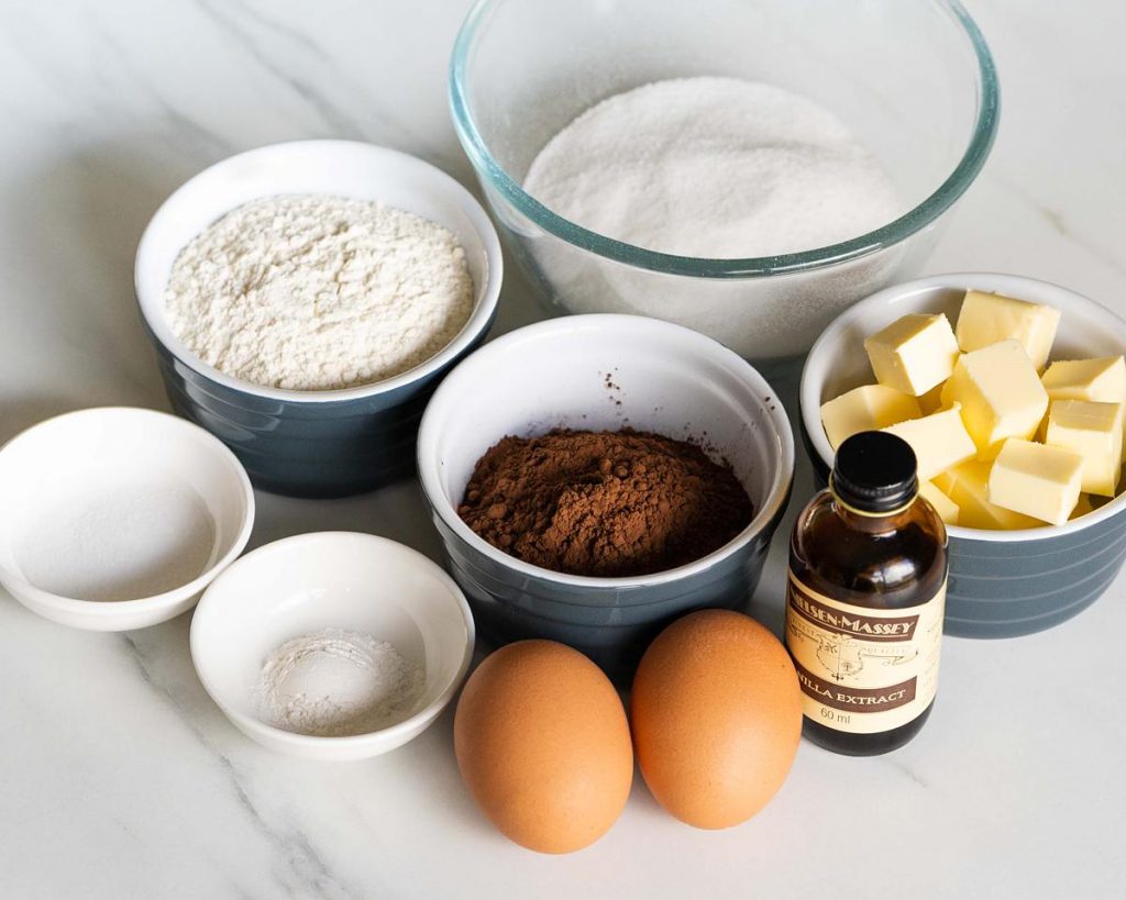 ingredients for brownie base: unsalted butter, cocoa powder, caster sugar, eggs, vanilla, plain flour, salt and baking powder. Recipe by movers and bakers