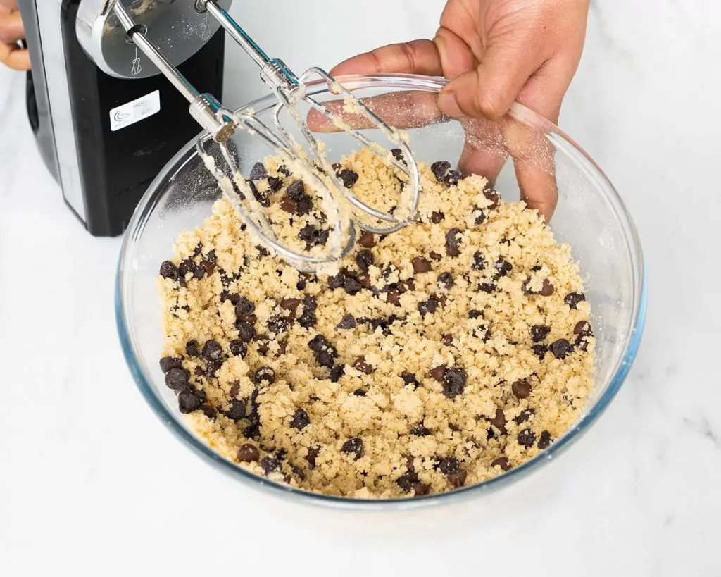The cookie dough starts to come together ready to be scooped before chilling. Recipe by movers and bakers