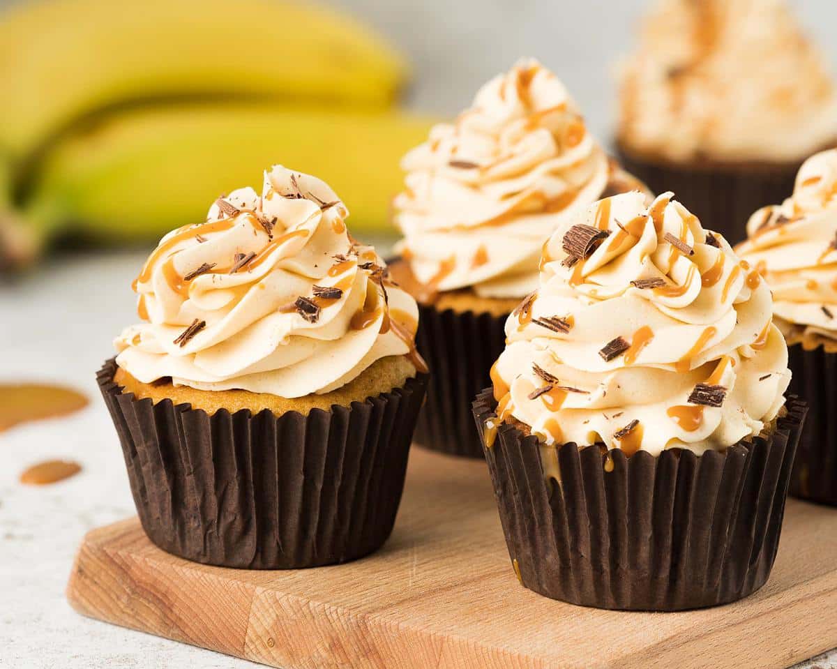 Banoffee cupcakes. Beautiful banoffee cupcakes with a biscuit base, hidden caramel centre, caramel buttercream and chocolate shavings. Perfect for all banana and caramel lovers! Recipe by movers and bakers