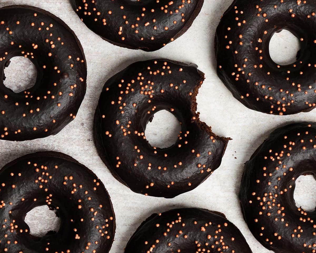 Bronuts aka brownie donuts are delicious fudgy chocolate brownies in a donut form! Smothered in a rich chocolate glaze and lots of sprinkles, these deep rich donuts are sure to be a crowd pleaser! Recipe by movers and bakers