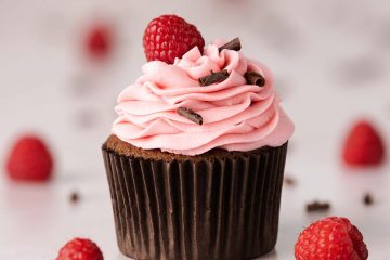 My chocolate raspberry cupcakes are delicious light and fluffy chocolate cupcakes topped with a tangy and sweet fresh raspberry buttercream. It is crowned with chocolate curls and a single raspberry to finish. Recipe by movers and bakers