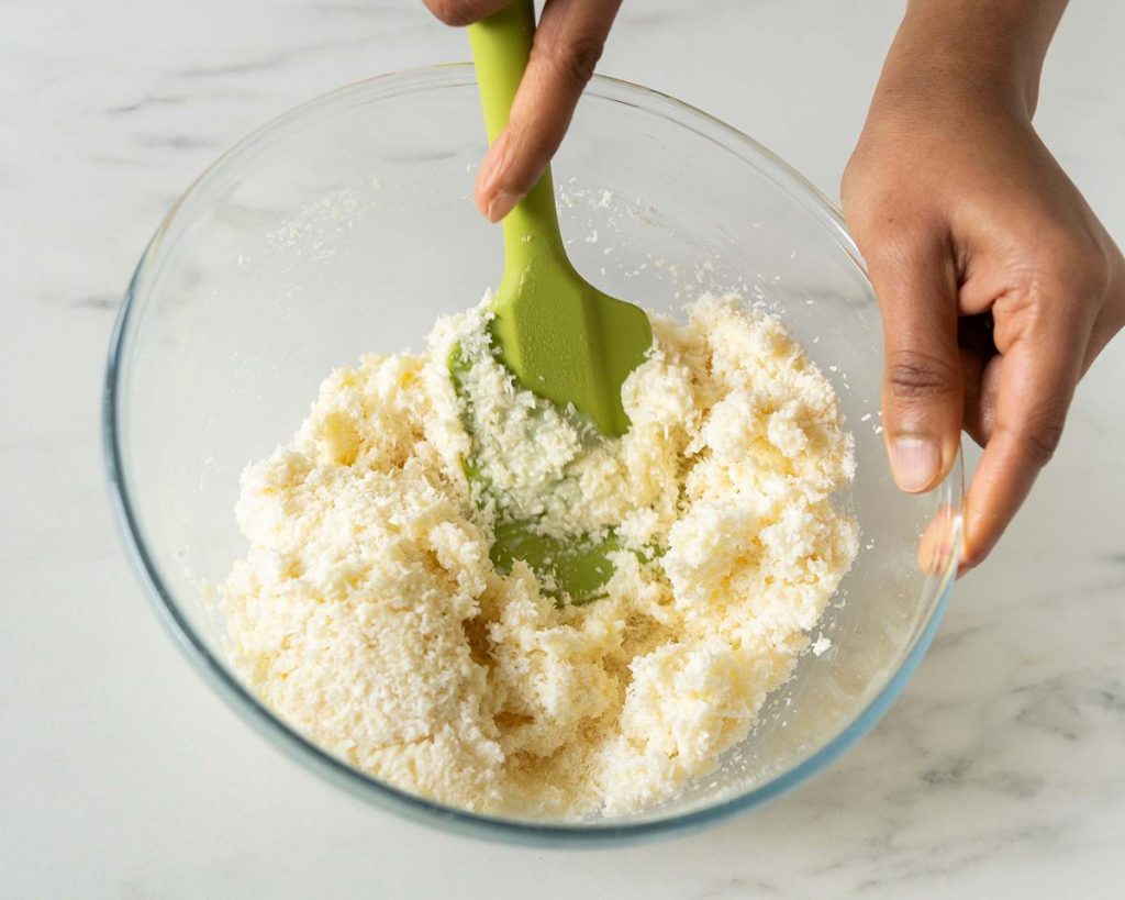 Mixing together the ingredients before scooping and baking. Recipe by movers and bakers