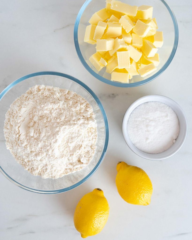 Ingredients required for the biscuits: caster sugar, unsalted butter, lemons (zest only) and plain (all purpose) flour. Recipe by movers and bakers