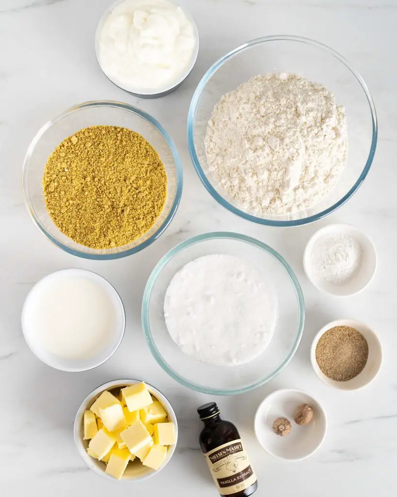 Ingredients needed for the cake: roughly ground pistachio nuts, plain (all purpose) flour, baking powder, cardamom powder, grated nutmeg, unsalted butter, caster sugar, vanilla, (Greek) yogurt and whole milk. Recipe by movers and bakers
