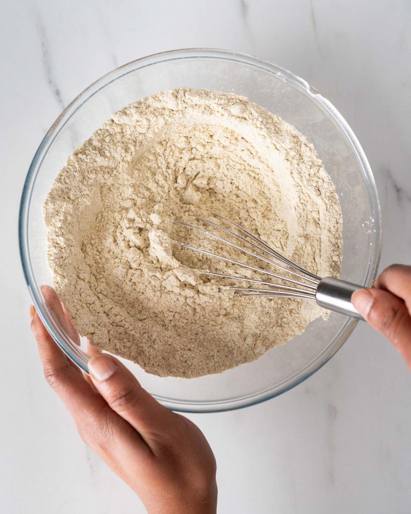 Whisking the dry ingredients together after sifting. Recipe by movers and bakers