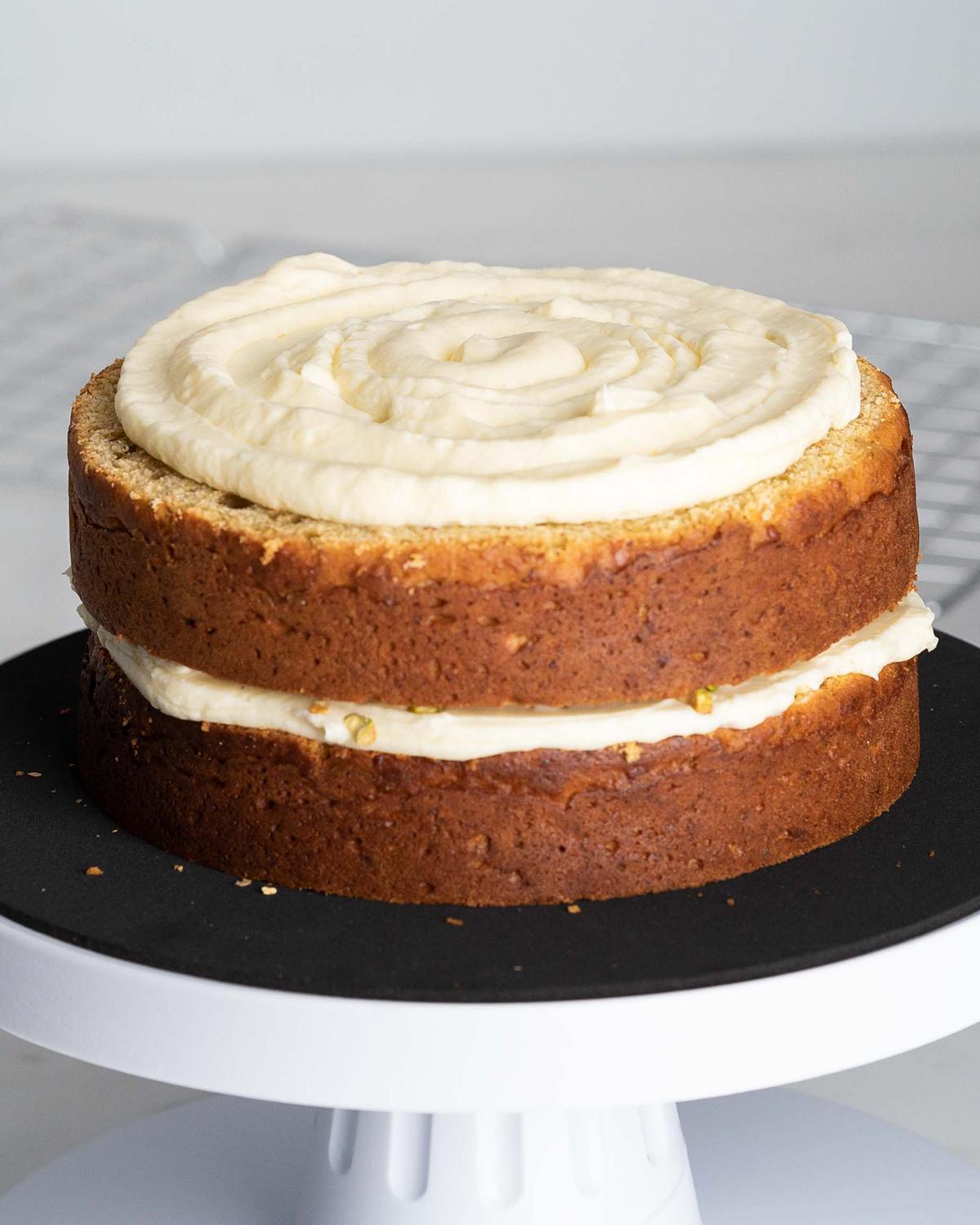 Pipe or spread buttercream in between the layers and over the top and sides of the cake...
