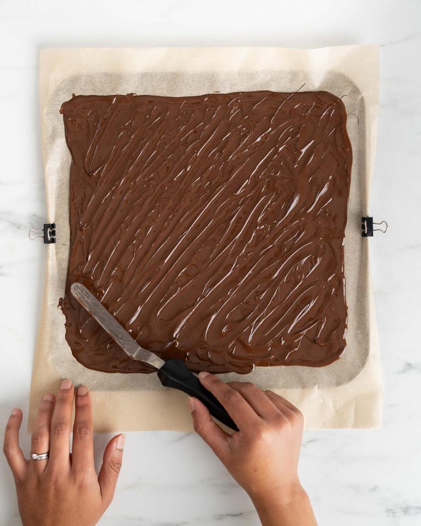 The chocolate bark is given texture before being left to set. Recipe by movers and bakers