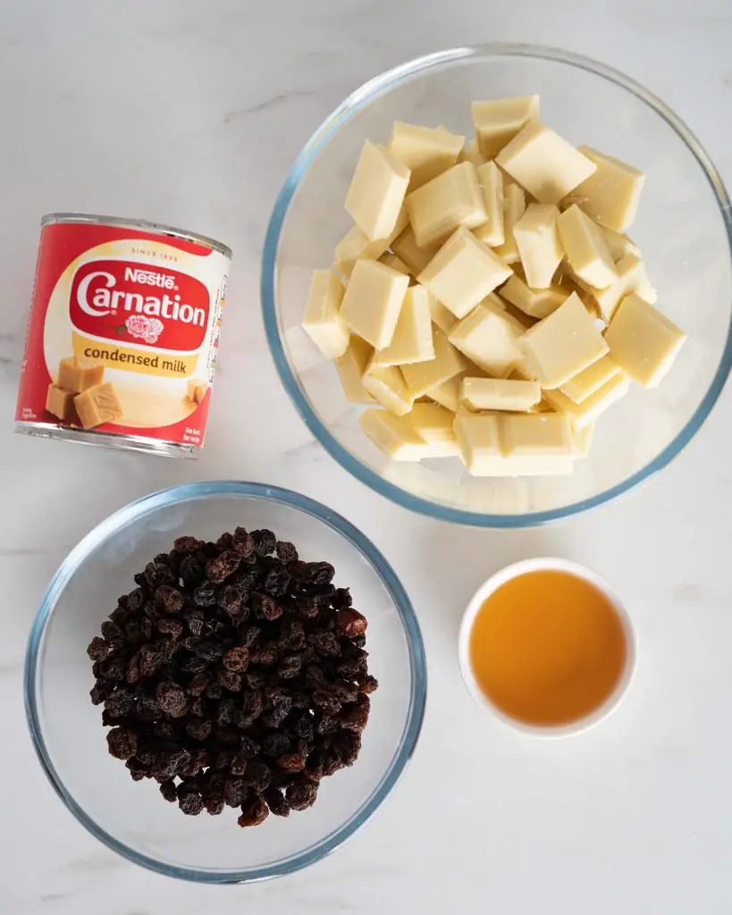 Ingredients required: white chocolate, condensed milk, raisins and dark rum. Recipe by movers and bakers
