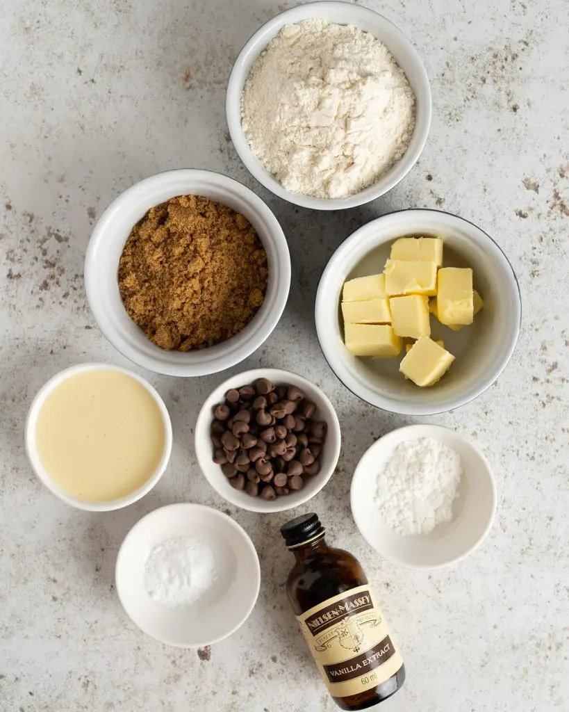 Ingredients needed: unsalted butter, brown sugar, condensed milk, vanilla, plain (all purpose) flour, cornflour (cornstarch), bicarbonate of soda (baking soda) and chocolate chips. Recipe by movers and bakers