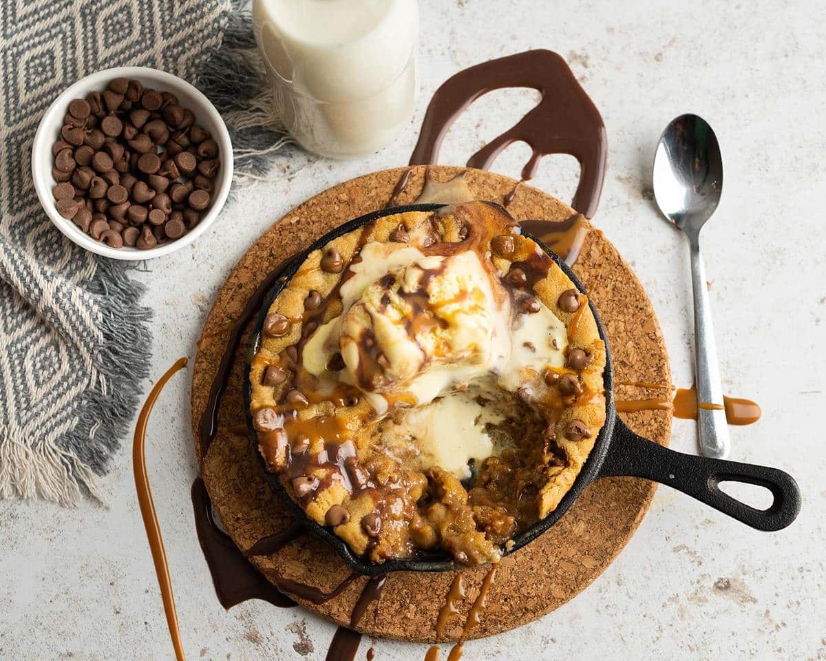 Chocolate chip skillet cookie. Wonderfully crisp on the outside and soft and chewy in the middle. Perfect served with ice cream and lashings of sauce drizzled all over! Recipe by movers and bakers