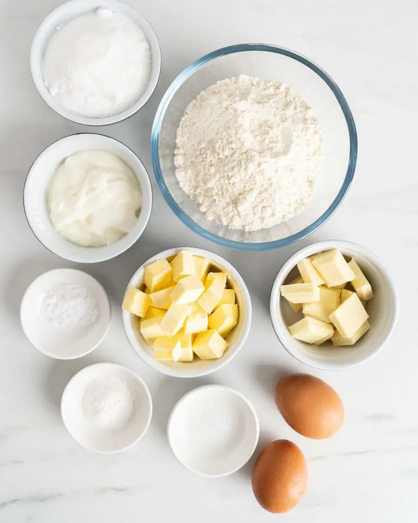 Ingredients required: white chocolate, unsalted butter, caster sugar, plain (all purpose) flour, baking powder, bicarbonate of soda (baking soda), salt, eggs and yogurt. Recipe by movers and bakers