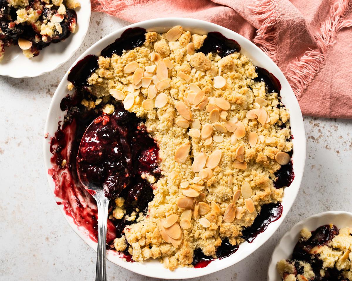 Cherry bakewell crumble. Sweet cherry filling topped with a crisp almond crumble topping makes a wonderful winter warmer dessert. Recipe by movers and bakers