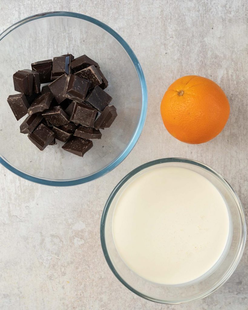 Ingredients for the ganache: dark chocolate, double (heavy) cream and orange zest. Recipe by movers and bakers