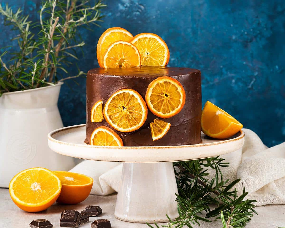 Chocolate orange cake. Rich, decadent and moist, this chocolate orange cake is filled and covered with a dark chocolate orange ganache and decorated with some dehydrated oranges. Simply stunning! Recipe by movers and bakers