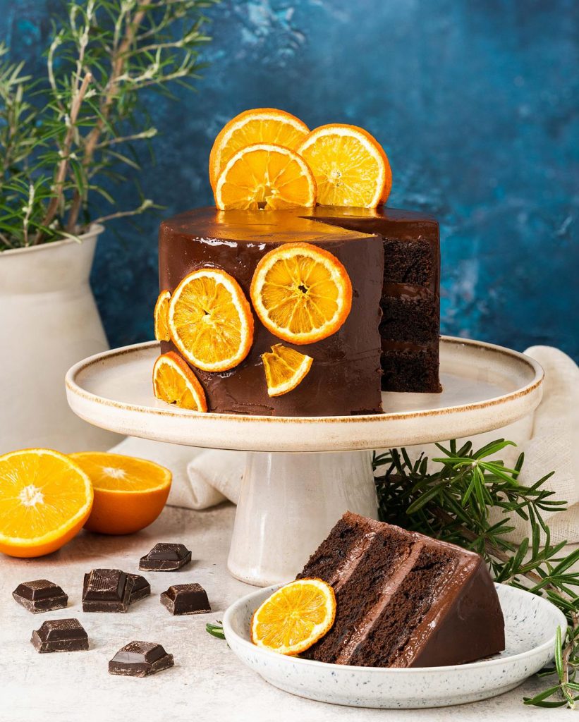 Chocolate orange cake. Rich, decadent and moist, this chocolate orange cake is filled and covered with a dark chocolate orange ganache and decorated with some dehydrated oranges. Simply stunning! Recipe by movers and bakers