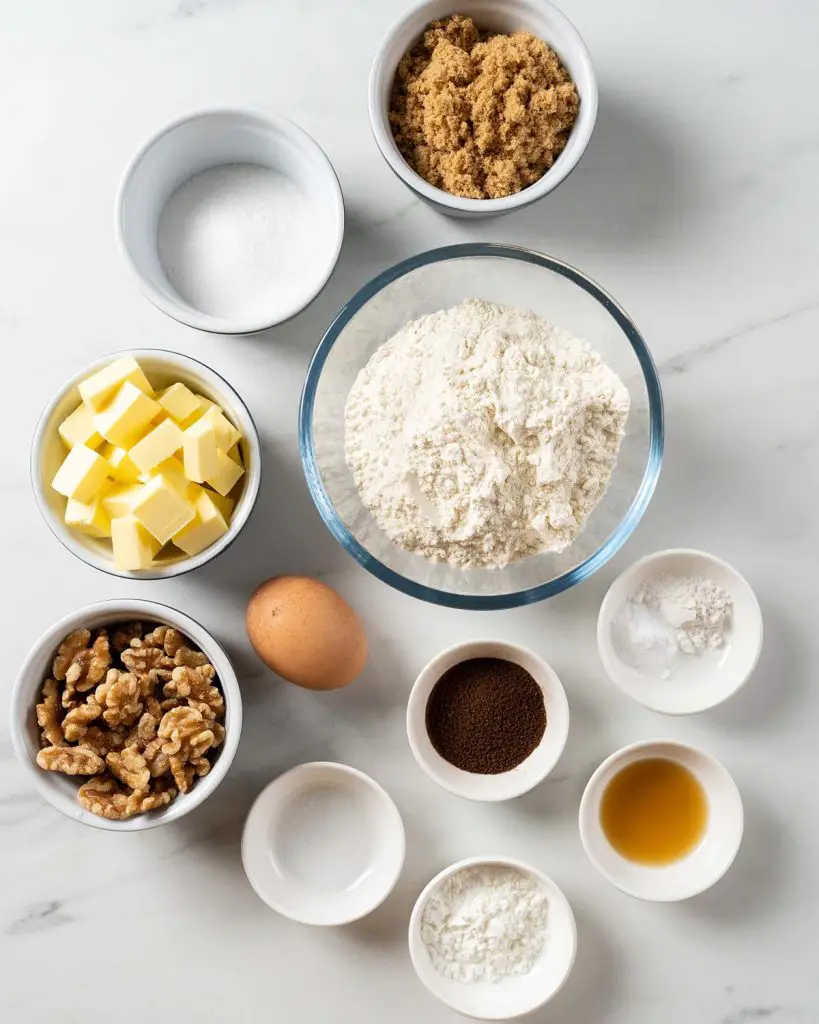Ingredients required: unsalted butter, caster sugar, brown sugar, egg, vanilla, plain (all purpose) flour, baking powder, bicarbonate of soda (baking soda), salt, cornflour (cornstarch), instant coffee powder and walnuts. Recipe by movers and bakers