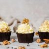 Carrot cake cupcakes. Moist and fluffy spiced carrot cake cupcakes with walnuts topped with a delicious tangy cream cheese frosting and decorated with walnuts. Recipe by movers and bakers