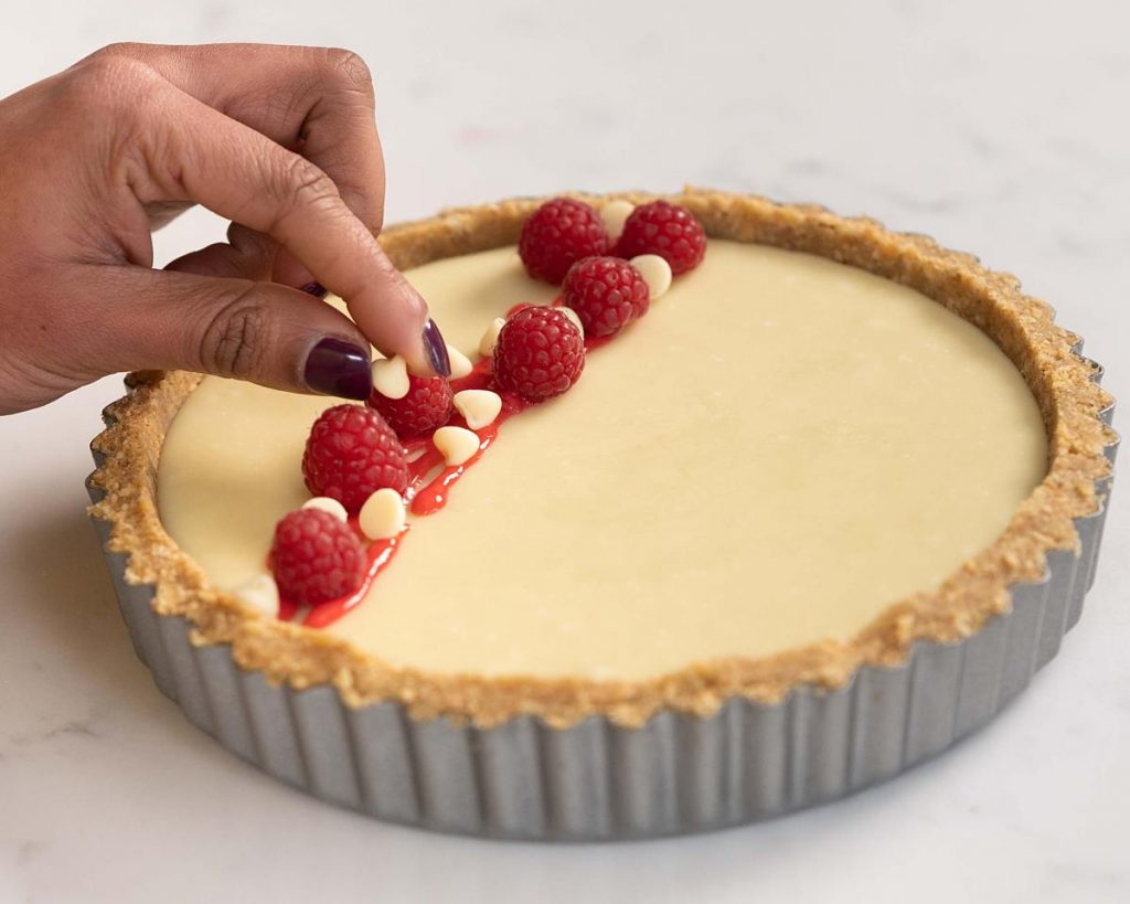 Adding the finishing touches to the tart. Recipe by movers and bakers
