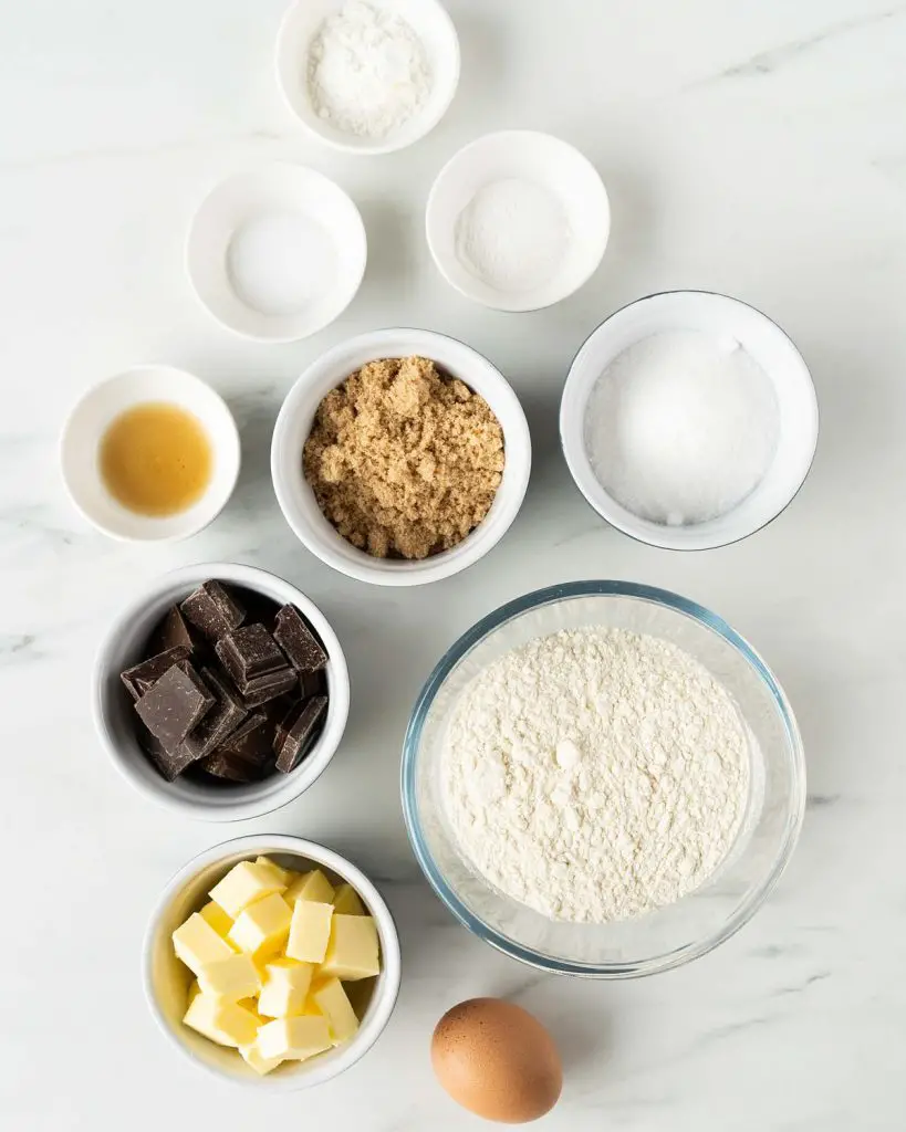 Ingredients required: unsalted butter, brown sugar, caster sugar, vanilla, egg, plain (all purpose) flour, baking powder, cornflour (cornstarch), salt and dark chocolate. Recipe by movers and bakers