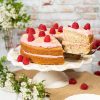 Raspberry almond cake. This vegan cake has moist almond cake layers, a fresh raspberry buttercream and lots of raspberries and flaked almonds to decorate. Recipe by movers and bakers