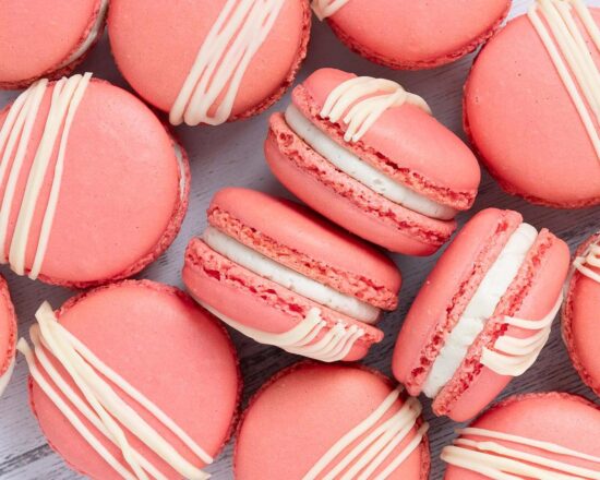 Strawberry macarons. Crisp, chewy, sweet, soft and nutty. And totally irresistible, filled with sweet vanilla buttercream and delicious strawberry jam. Recipe by movers and bakers