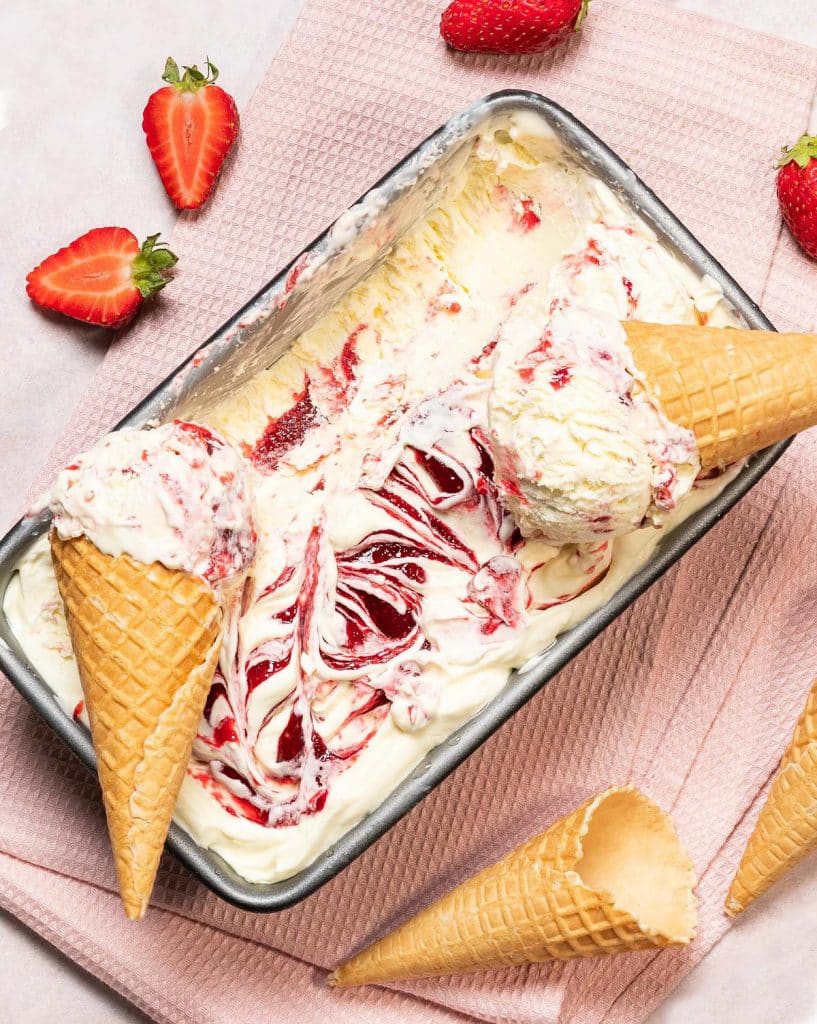 Strawberry ripple ice cream. Rich and creamy vanilla ice cream swirled with a delicious strawberry compote, perfect for summertime cooling down! Recipe by movers and bakers