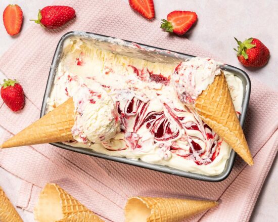 Strawberry ripple ice cream. Rich and creamy vanilla ice cream swirled with a delicious strawberry compote, perfect for summertime cooling down! Recipe by movers and bakers