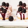Blackberry cheesecake. An almond biscuit base is topped with a creamy blackberry cheesecake filling and finished with a blackberry drizzle, flaked almonds and some fresh fruit. Recipe by movers and bakers