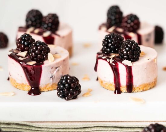 Blackberry cheesecake. An almond biscuit base is topped with a creamy blackberry cheesecake filling and finished with a blackberry drizzle, flaked almonds and some fresh fruit. Recipe by movers and bakers