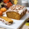 My pumpkin spice loaf cake is moist and delicate, gently spiced with warm pumpkin spice and topped with an irresistible maple spiced glaze and pecan pieces. Recipe by movers and bakers