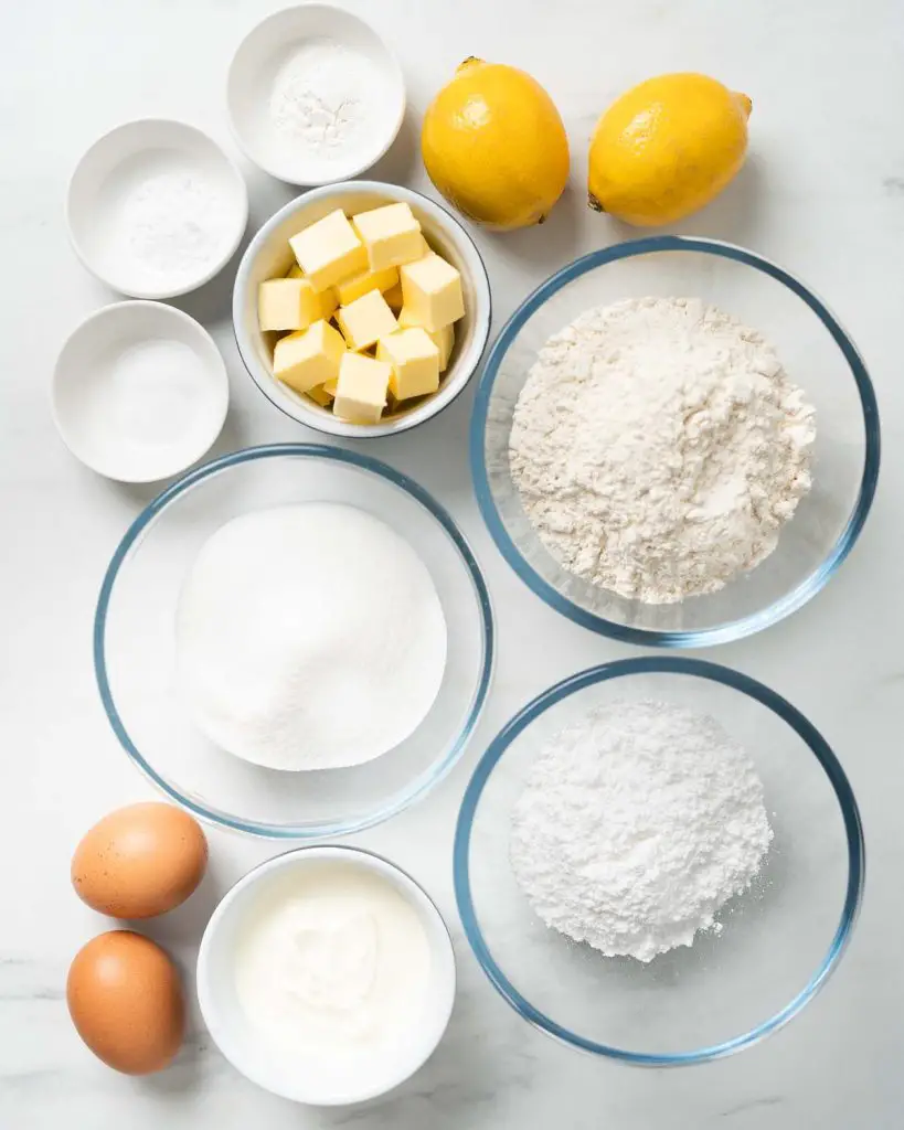 Ingredients required: caster sugar, lemons, unsalted butter, plain (all purpose) flour, baking powder, bicarbonate of soda (baking soda), salt, eggs, yogurt and icing sugar. Recipe by movers and bakers