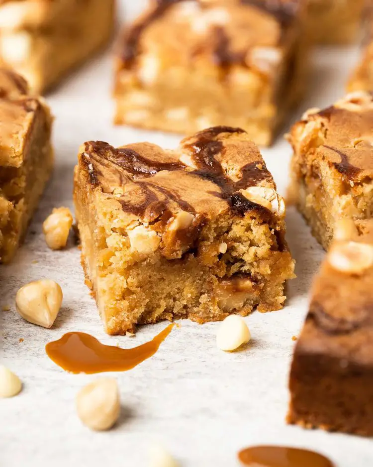 Salted caramel blondies. Soft and fudgy blondies packed with salted caramel, white chocolate chips and hazelnut halves make a delicious mix of flavours and textures! Recipe by movers and bakers