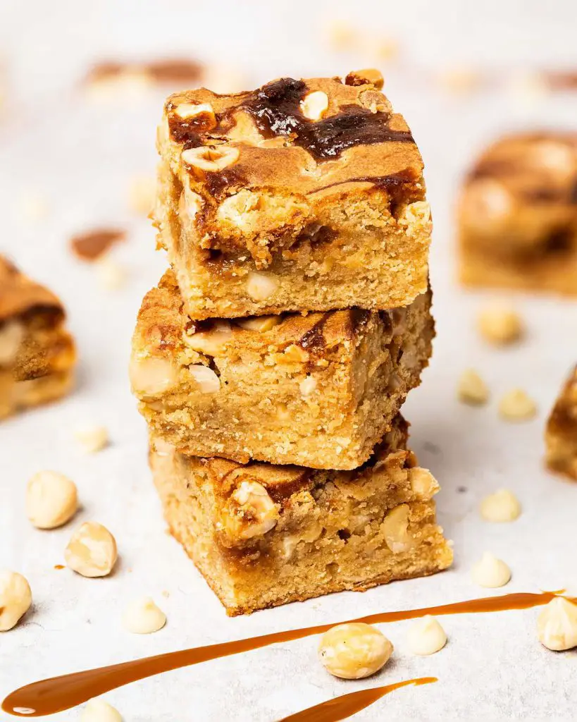 Salted caramel blondies. Soft and fudgy blondies packed with salted caramel, white chocolate chips and hazelnut halves make a delicious mix of flavours and textures! Recipe by movers and bakers